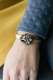 woman wearing a vintage inspired watch bracelet with colourful jewels