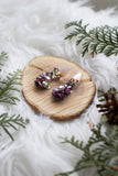 vintage purple rhinestone earrings on wood with greenery holiday handmade in toronto
