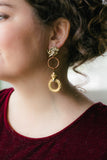 girl with curly hair wearing long gold hoop statement earrings handmade in toronto