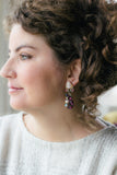 girl in sparkly sweater with purple and pink long vintage earrings handmade in toronto