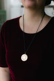 vintage gold locket with black chain on red velvet dress handmade in toronto