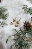 jewelry surrounded by greenery for the holidays handmade in toronto